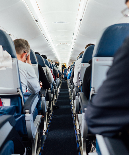 Showing a group of passengers on an airplane.