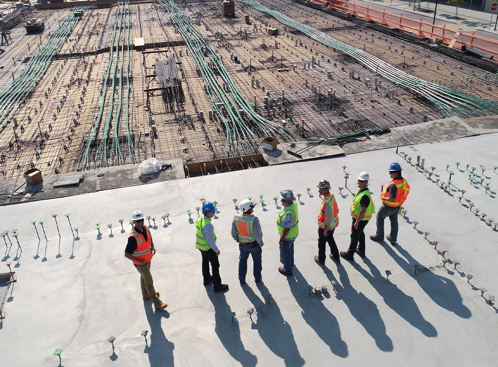 A group of construction workers analyzing a building plan